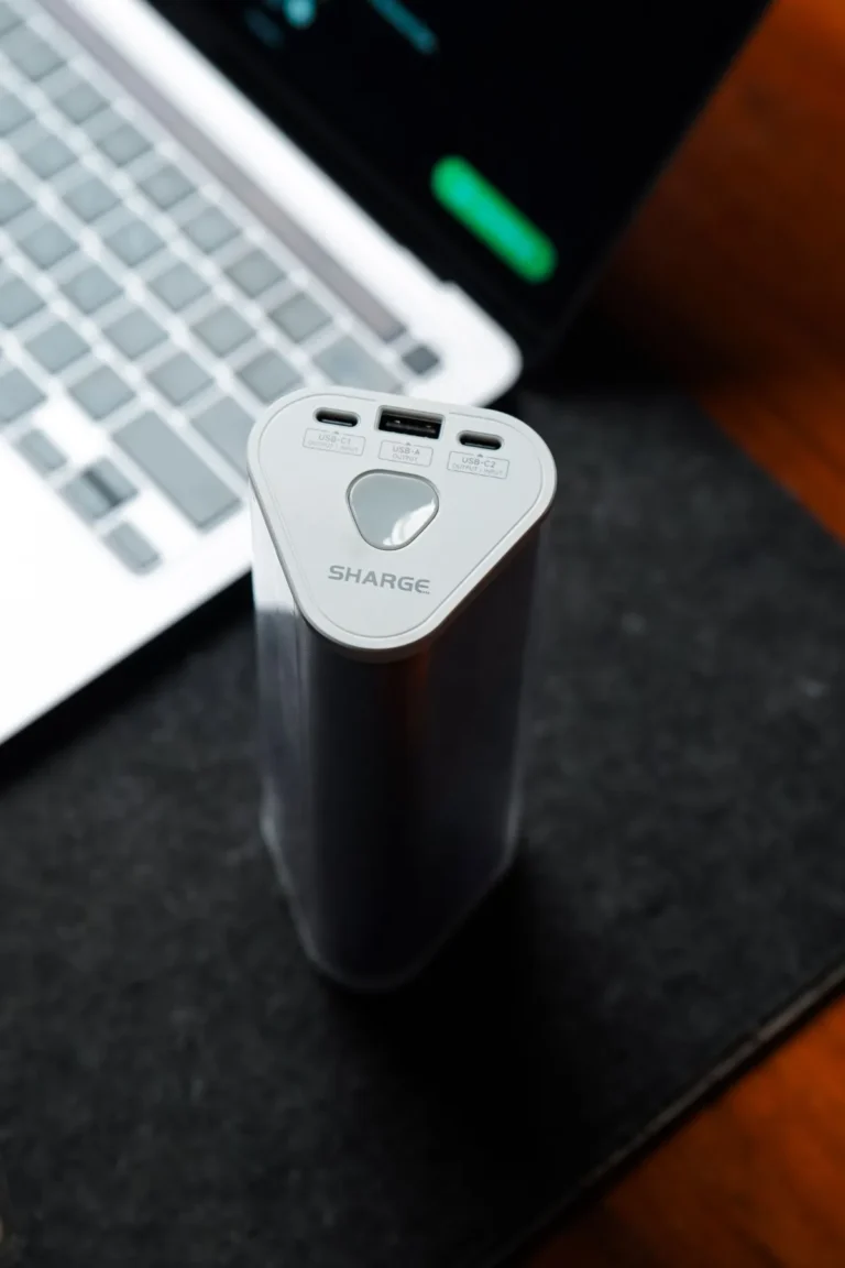 Compact power bank charging next to a laptop, representing the Anker SOLIX C1000 Gen 2 review