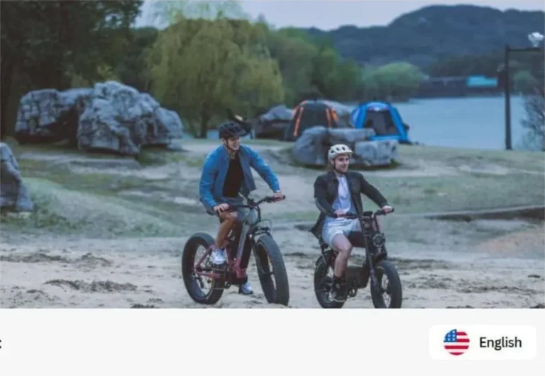 Two riders on electric bikes at a lakeside campsite where a portable power station could recharge the e-bikes