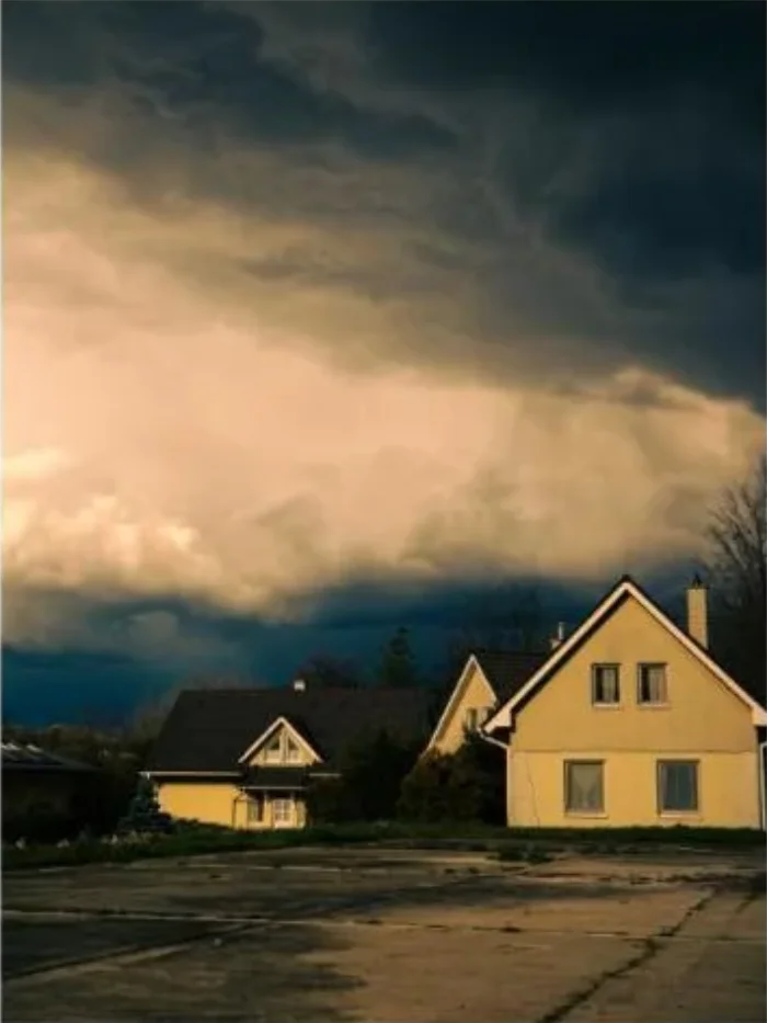Dramatic storm clouds gathering over houses ahead of hurricane season