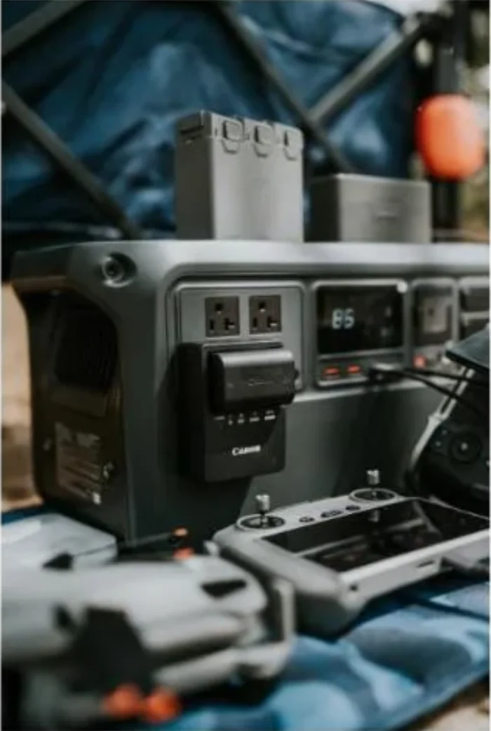 Portable power station with battery packs and cables set up outdoors