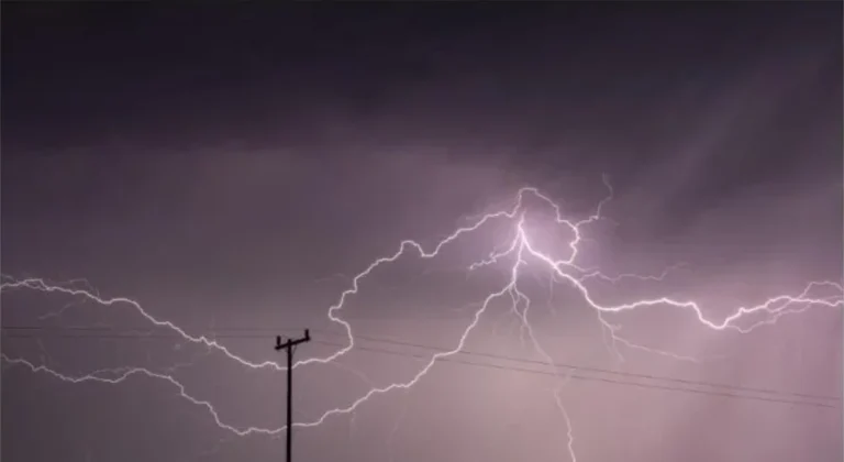 Dramatic lightning storm over power lines causing an outage risk