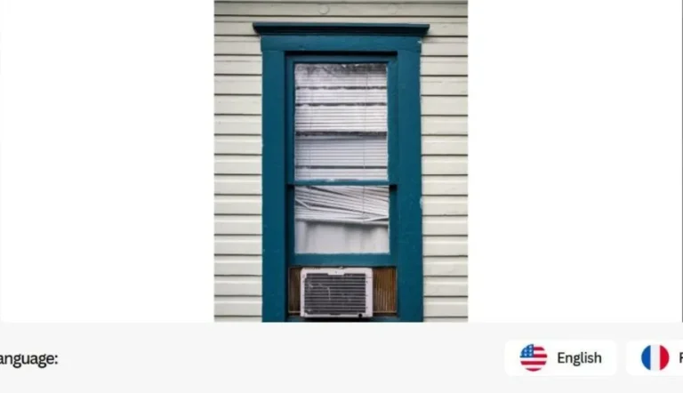 Window air conditioner unit installed in a home window, representing power station AC wattage needs